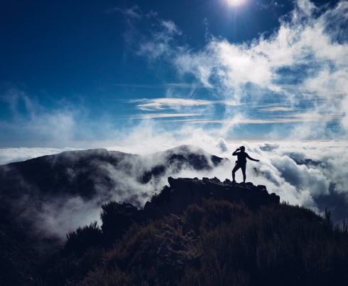 A person standing on a rock

Description automatically generated