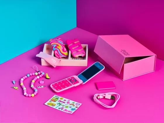 A pink cell phone and accessories  Description automatically generated