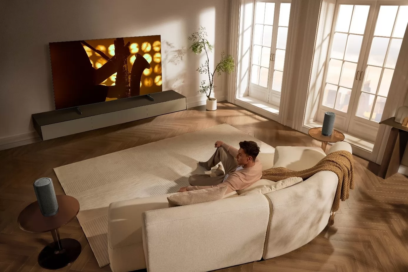 A person sitting on a couch in a living room AI-generated content may be incorrect., Obrázek